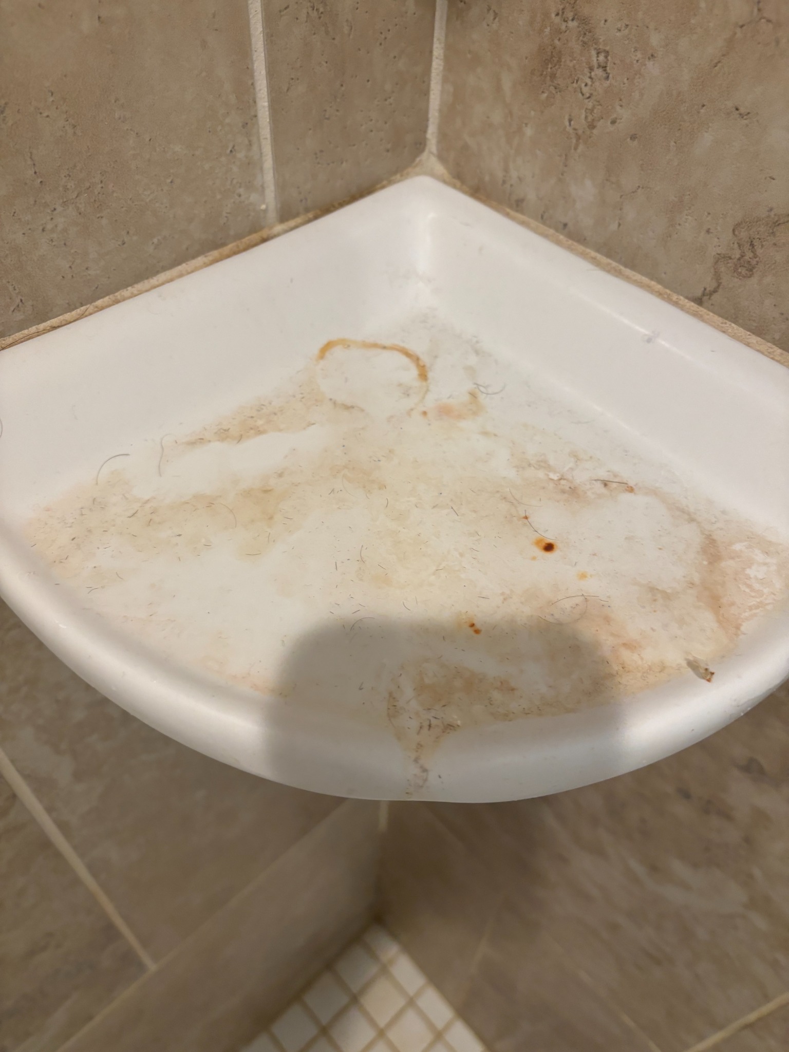 Before: shower shelf with buildup